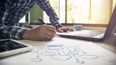 Cloud Migration Experts. A man draws a diagram of a cloud network