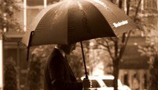 Cloud for Law firms - A man walks in the rain under an umbrella