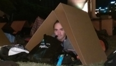 CEO Sleepout image - James in his cardboard box shelter
