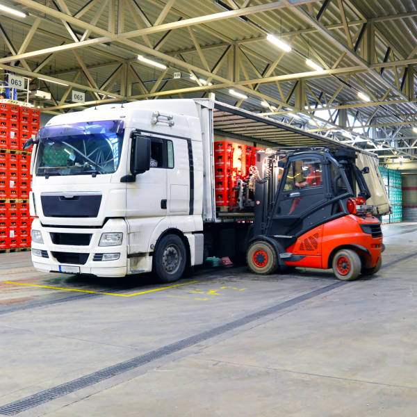 IT Support for Transport and Logistics. A forklift loads a truck