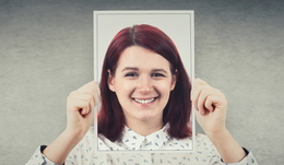 DMARC Email Security - a woman holds up a picture of herself in front of her face, but is it really her pitcure?