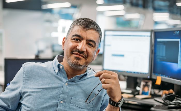 Building high performance IT Teams. A mature and experienced IT Manager looks at the camera, holding his glasses in one hand